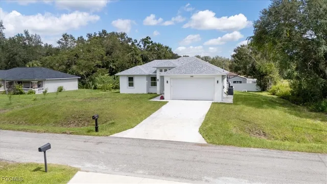 a front view of a house with a garden and yard