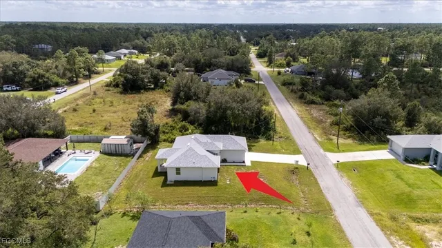 an aerial view of a house with a yard