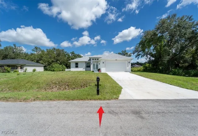 a view of backyard with swimming pool and outdoor seating