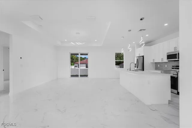 a view of kitchen with stainless steel appliances refrigerator oven and microwave