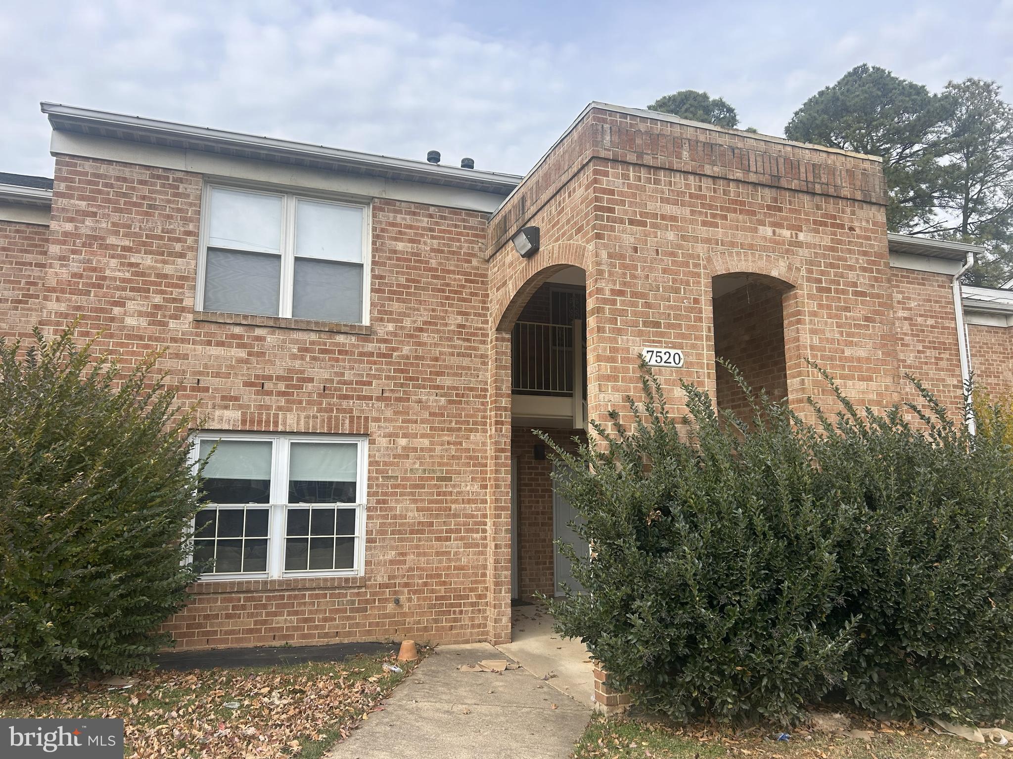 7520 Rhode Island Avenue, Unit A College Park, MD 20740 - Photo 1 of 2 a front view of a house with plants