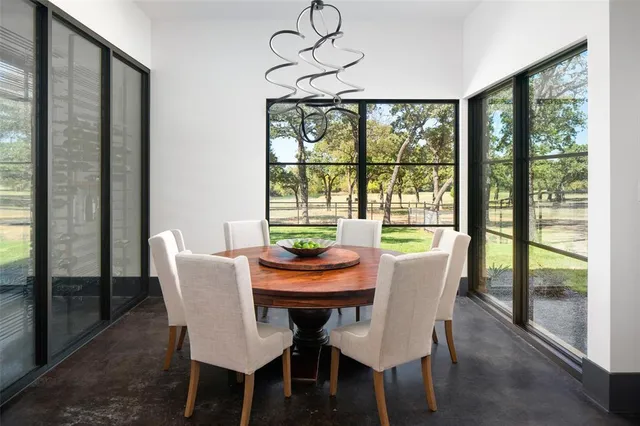a view of a dining room with furniture window and outside view