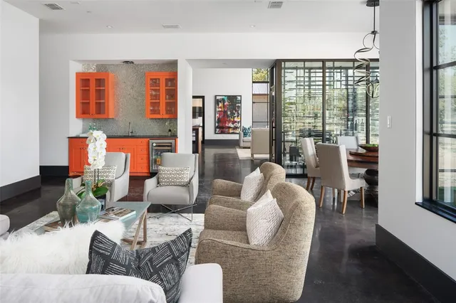 a living room with furniture fireplace and a large window