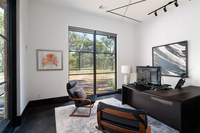 a view of workspace with wooden floor windows