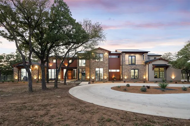 a front view of a building with trees around
