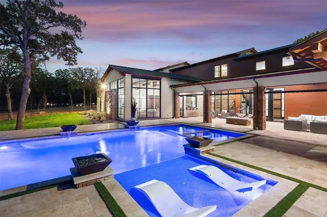 a swimming pool with outdoor seating and yard