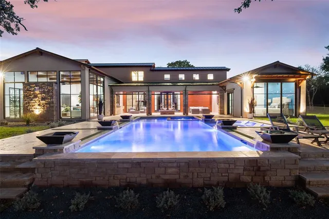 a view of a house with swimming pool and sitting area