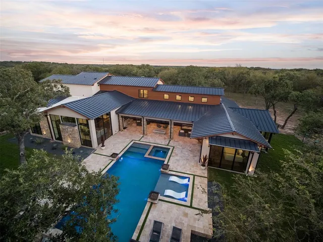 an aerial view of a house with a big yard