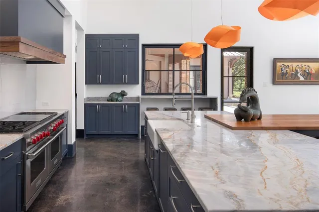 a room with a table chairs and a kitchen view