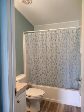 a bath room with a toilet and a shower