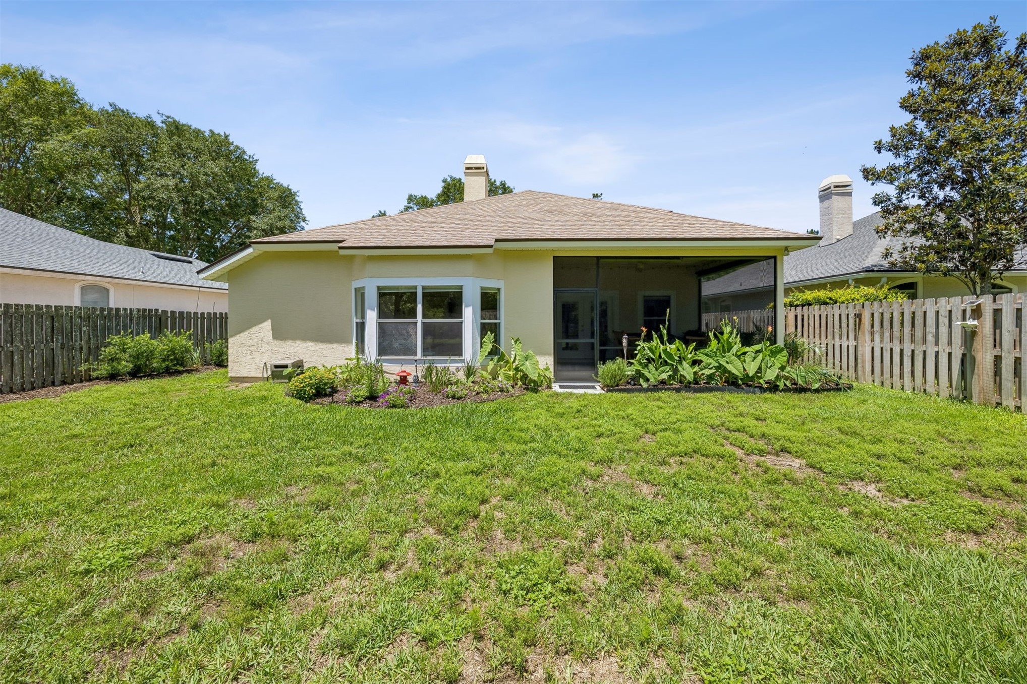 86107 Remsenburg Drive Fernandina Beach, FL 32034 - Photo 30 of 58 a front view of a house with garden
