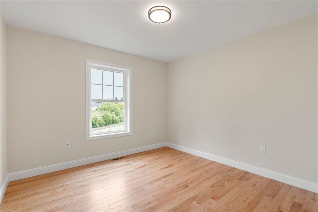 4 Bronson Street Fall River, MA 02721 - Photo 19 of 21 an empty room with wooden floor and windows