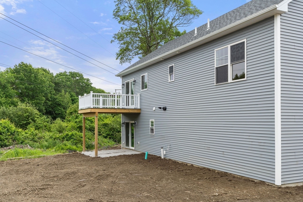 4 Bronson Street Fall River, MA 02721 - Photo 5 of 21 a view of a house with a yard and garage