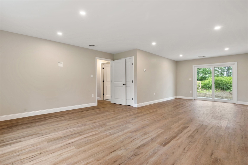 4 Bronson Street Fall River, MA 02721 - Photo 6 of 21 a view of an empty room with wooden floor and windows