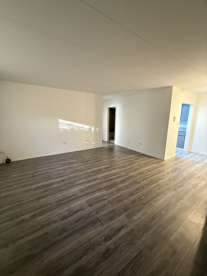 138 East Bailey Road, Unit B Naperville, IL 60565 - Photo 5 of 20 a view of an empty room with wooden floor