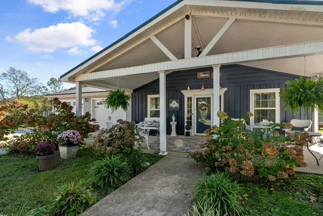 a backyard of a house with table and chairs