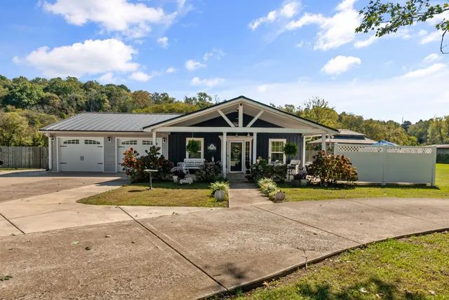 a view of a patio with a table chairs and a swimming pool
