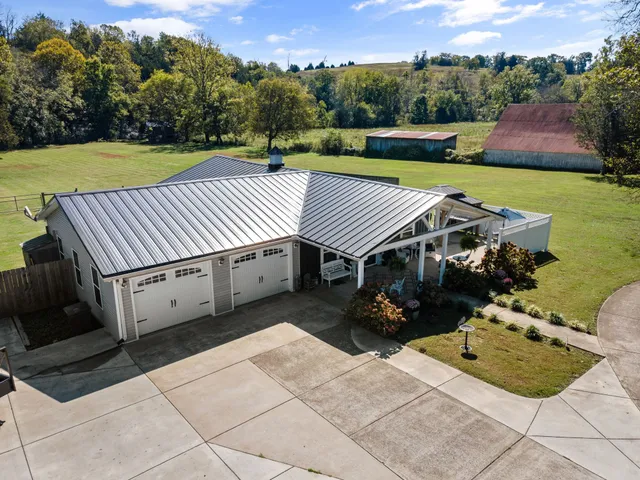 a view of a house with garden and pathway