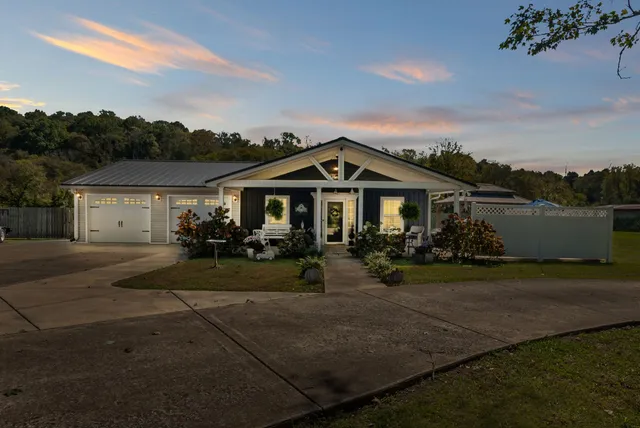 a large living room with stainless steel appliances furniture a rug and a view