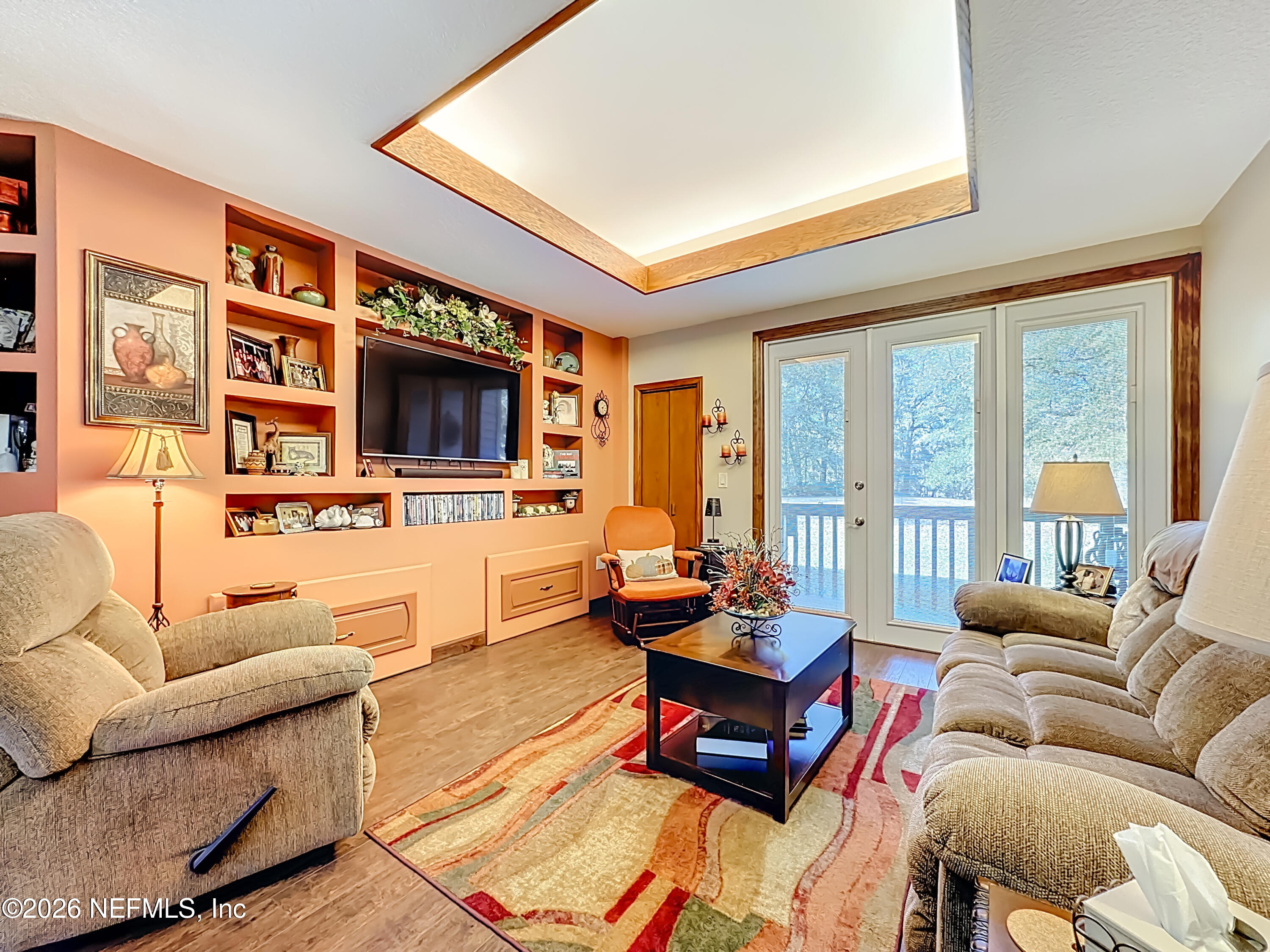 2910 Ravines Road, Unit 1103 Middleburg, FL 32068 - Photo 11 of 36 a living room with furniture and a flat screen tv