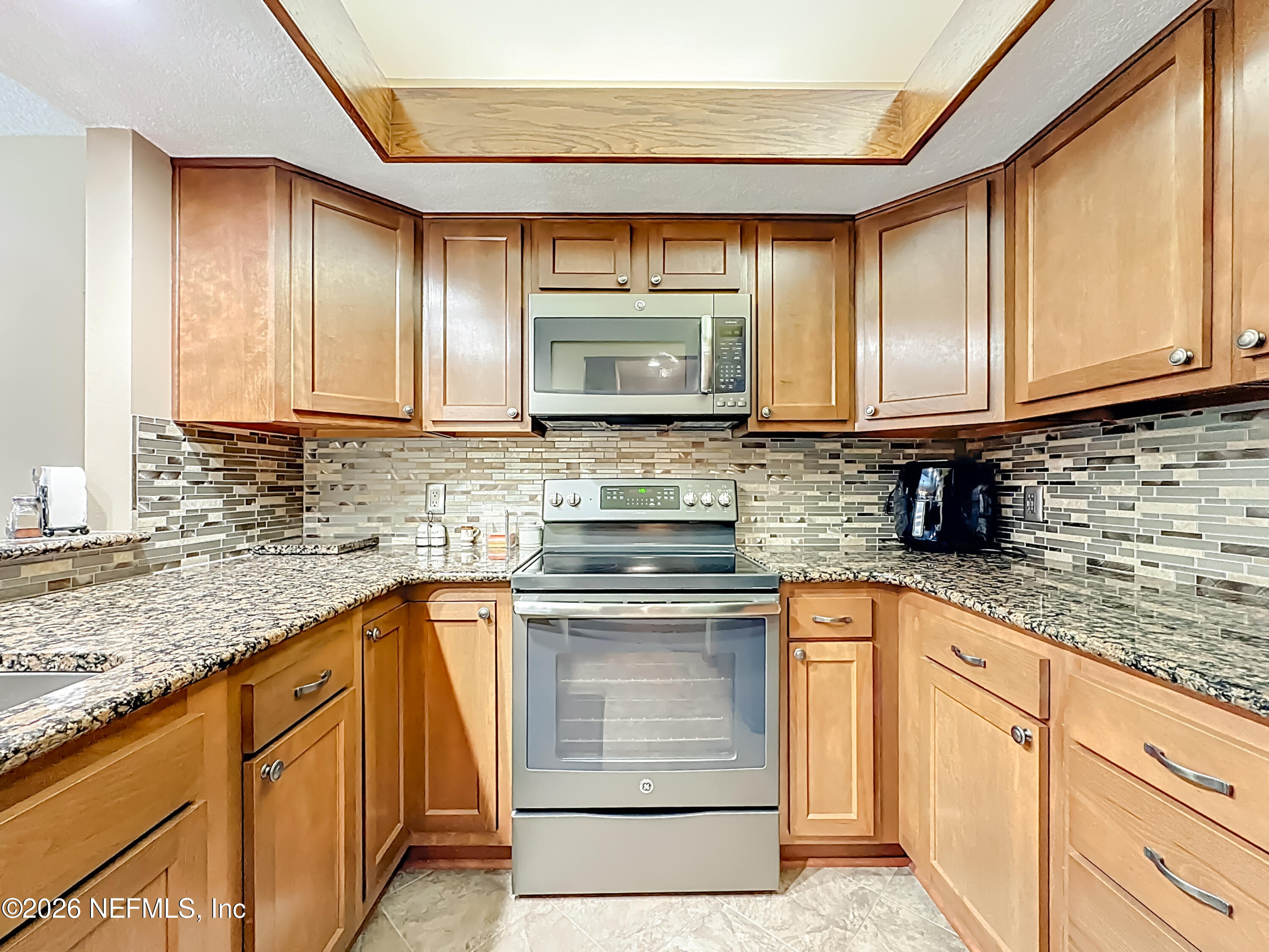 2910 Ravines Road, Unit 1103 Middleburg, FL 32068 - Photo 15 of 36 a kitchen with stainless steel appliances granite countertop a sink stove and cabinets