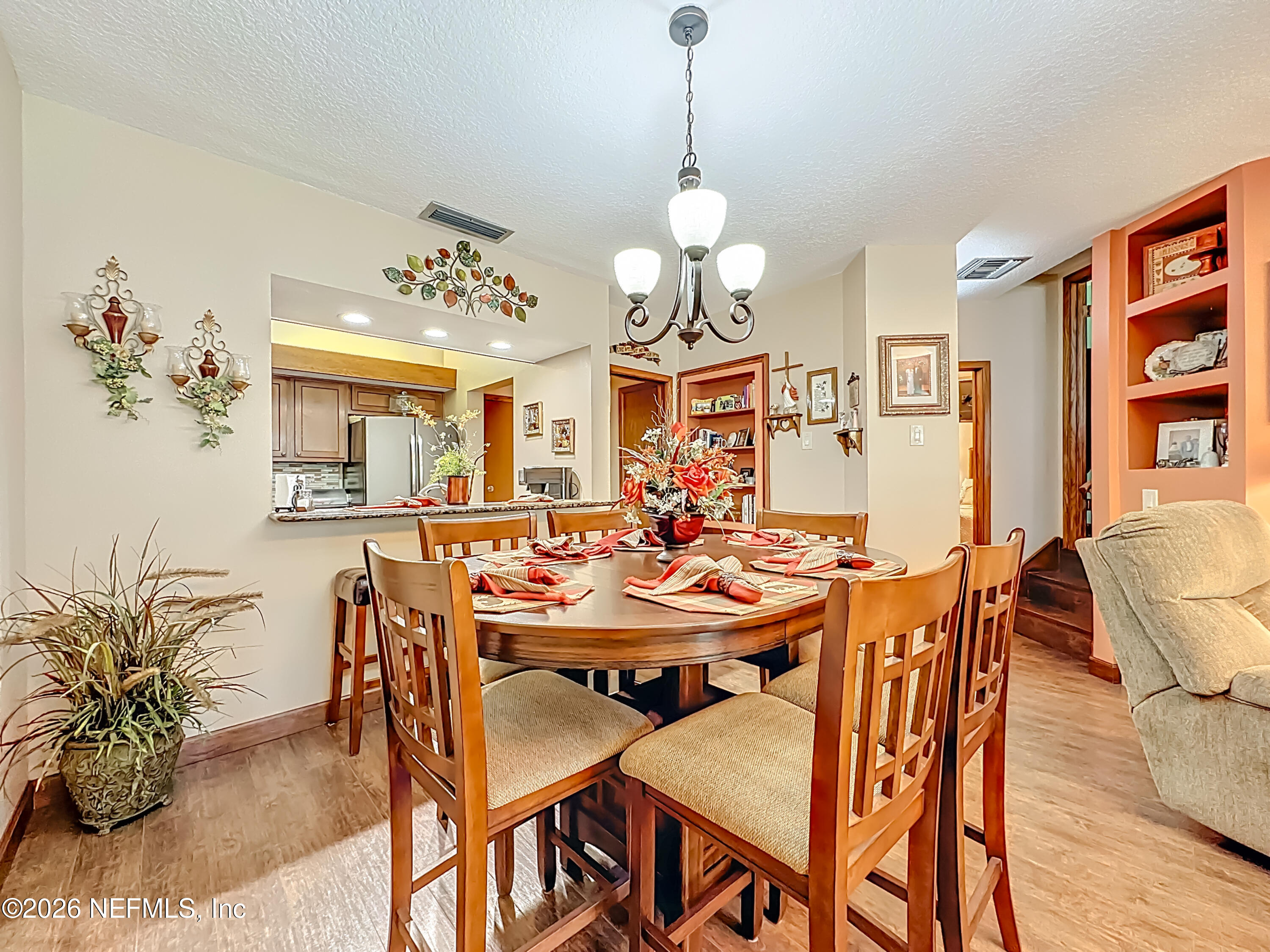 2910 Ravines Road, Unit 1103 Middleburg, FL 32068 - Photo 20 of 36 a view of a dining room with furniture window and wooden floor