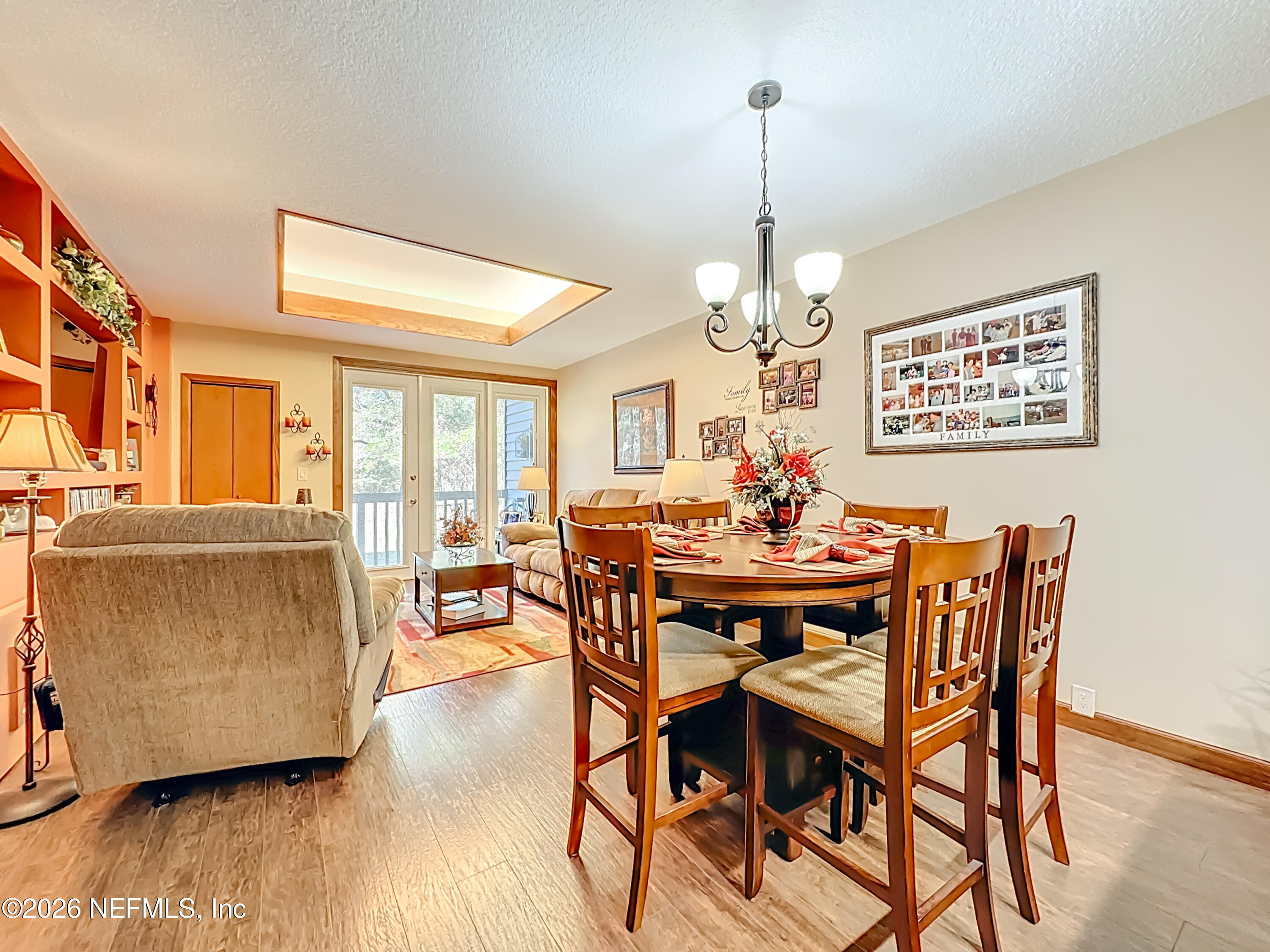2910 Ravines Road, Unit 1103 Middleburg, FL 32068 - Photo 21 of 36 a view of a dining room with furniture wooden floor and chandelier