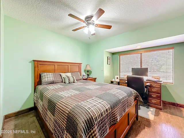 a bedroom with a bed and a table