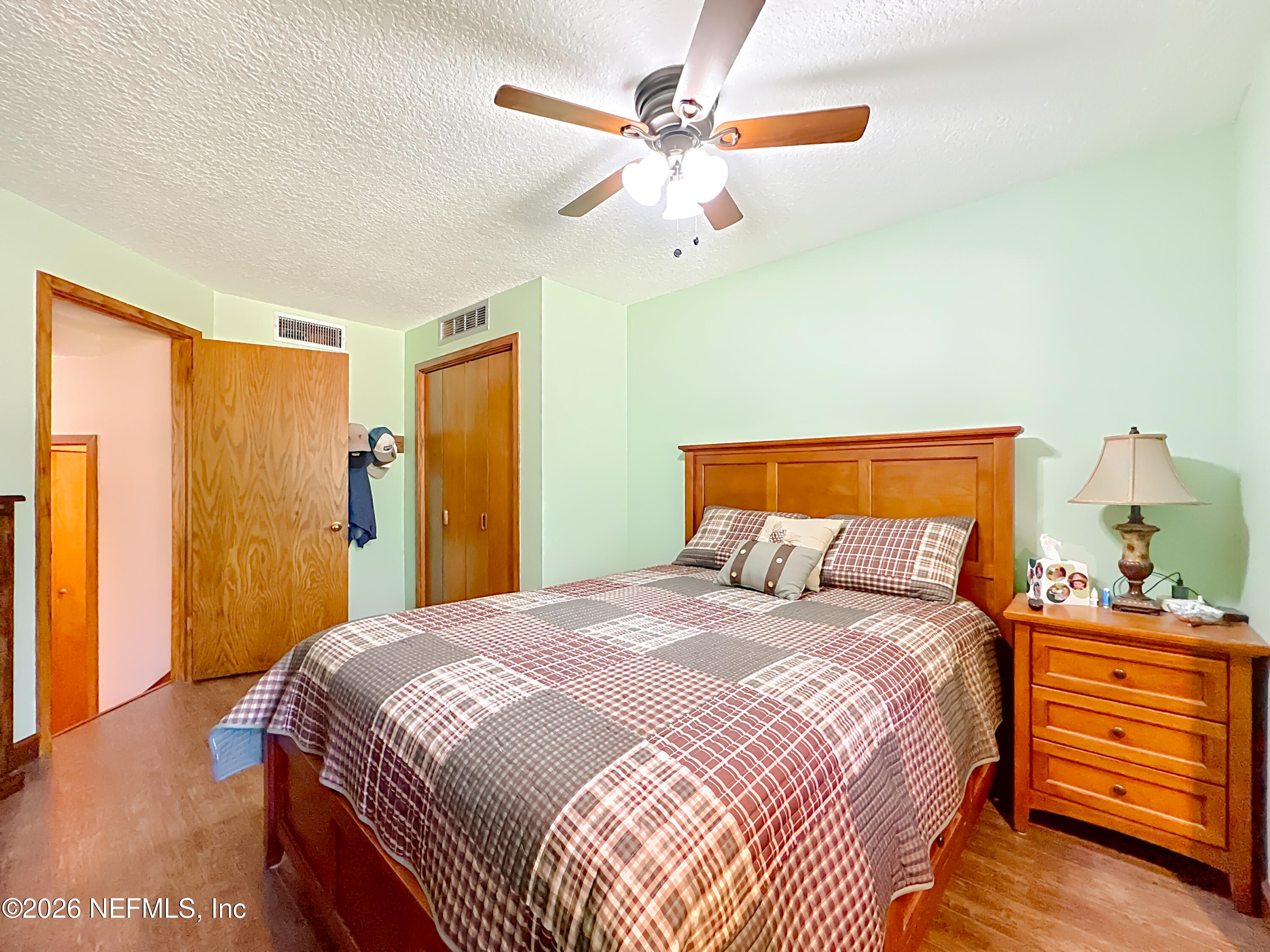 2910 Ravines Road, Unit 1103 Middleburg, FL 32068 - Photo 23 of 36 a bedroom with a bed and a dresser