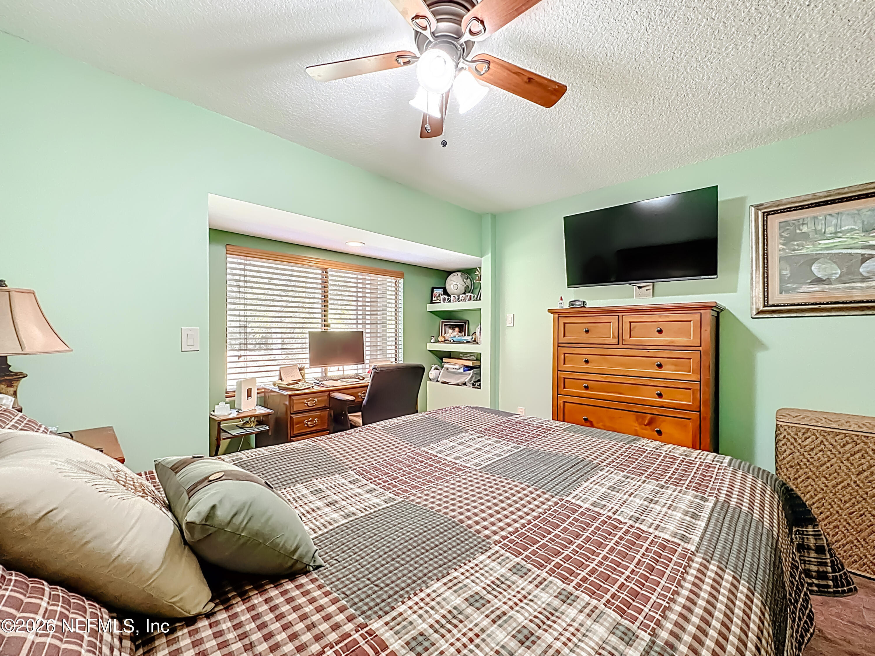 2910 Ravines Road, Unit 1103 Middleburg, FL 32068 - Photo 25 of 36 a bedroom with a bed and a flat screen tv