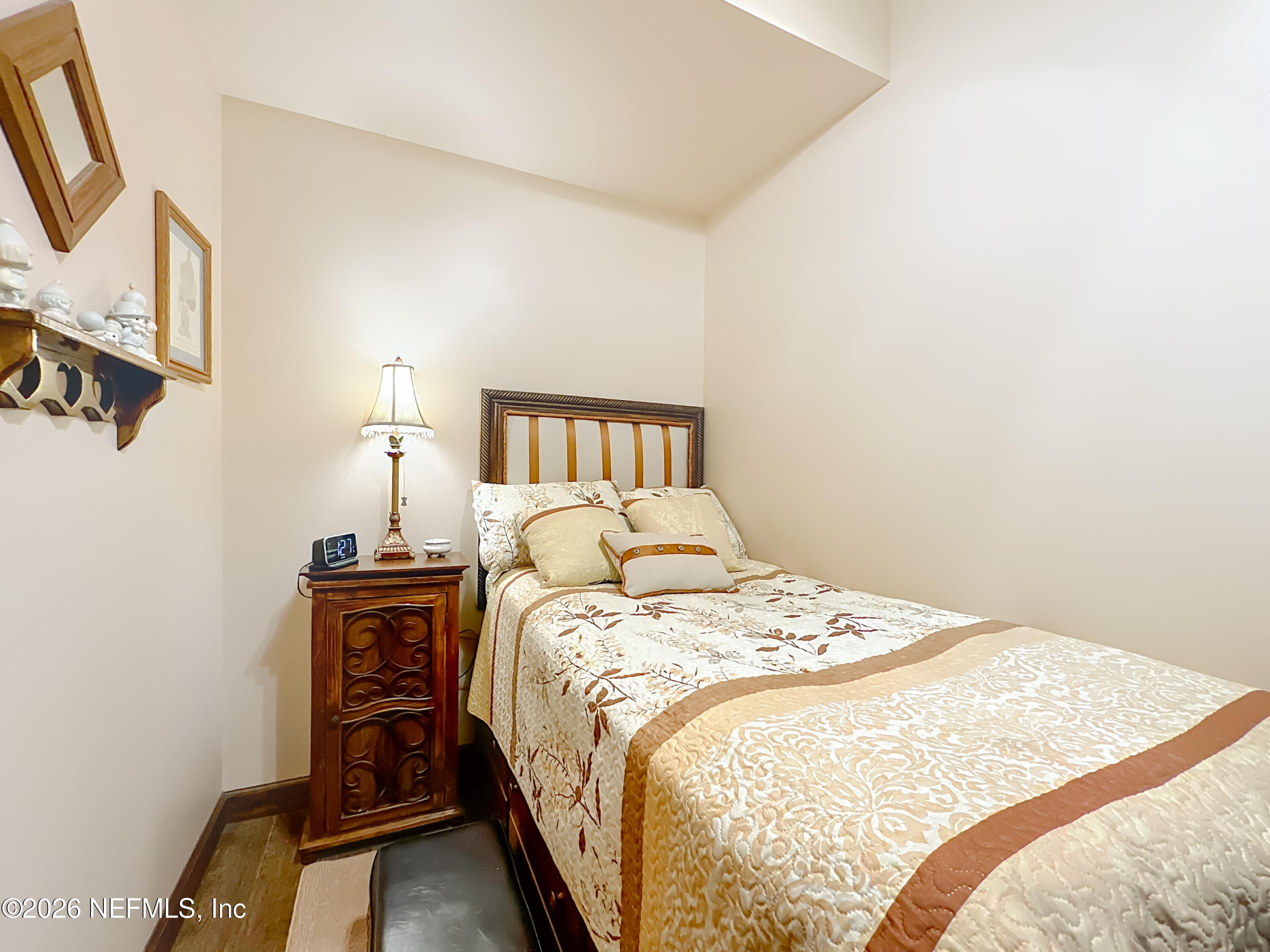 2910 Ravines Road, Unit 1103 Middleburg, FL 32068 - Photo 29 of 36 a bedroom with a bed and wooden floor