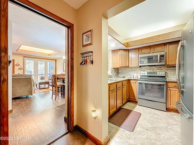 a kitchen with granite countertop a stove and a refrigerator