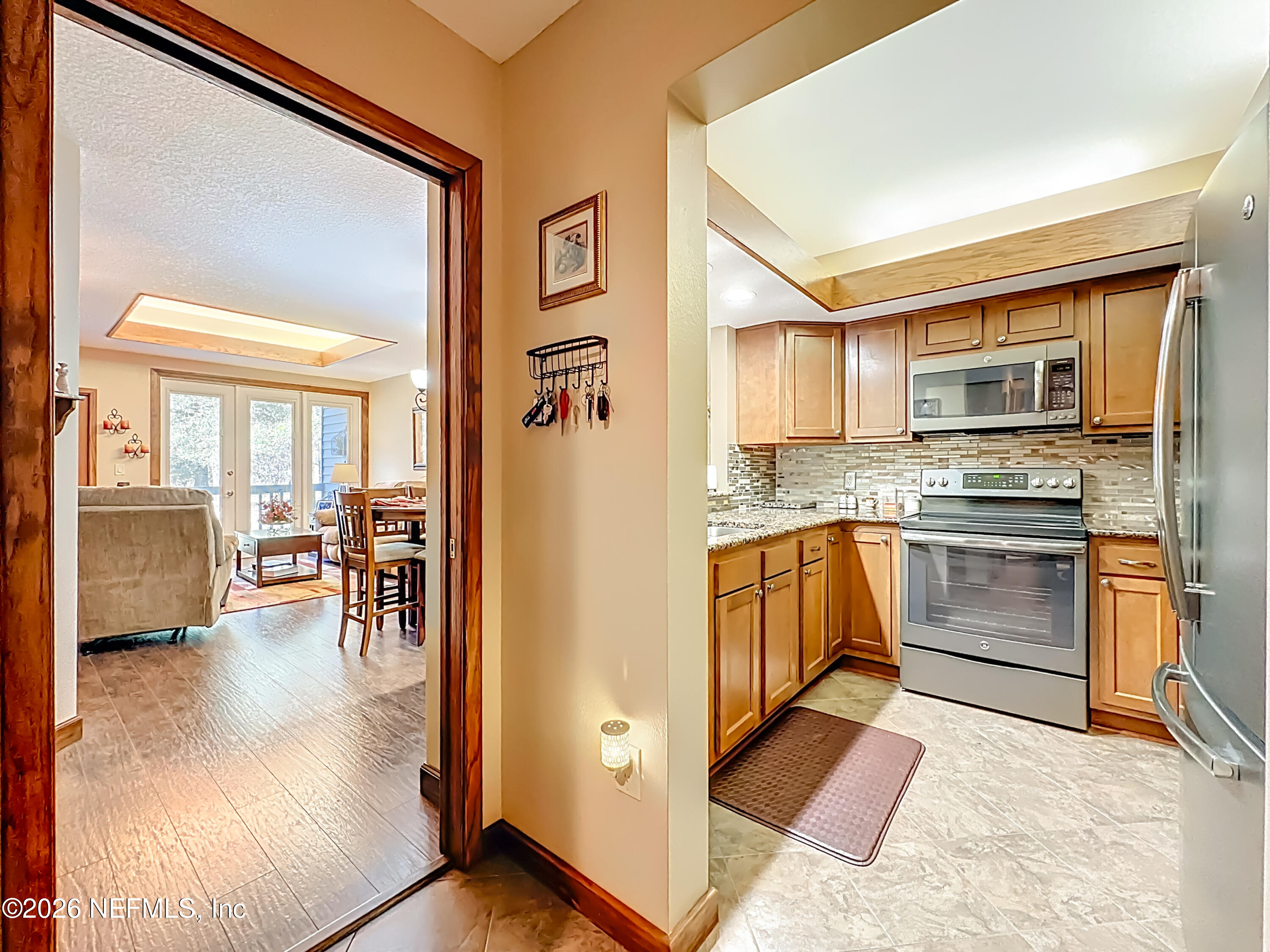 2910 Ravines Road, Unit 1103 Middleburg, FL 32068 - Photo 10 of 36 a kitchen with granite countertop a stove and a refrigerator