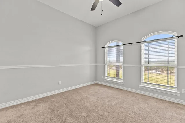 an empty room with windows and entrance