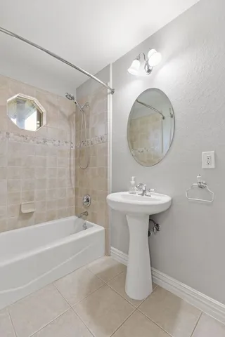 a bathroom with a sink a mirror and a bathtub
