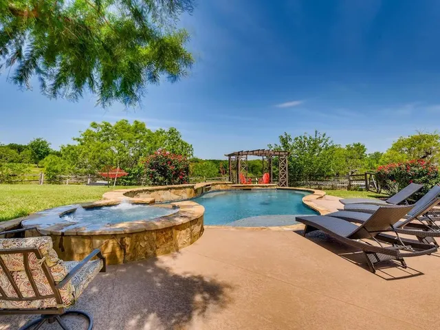 a swimming pool with outdoor seating and yard