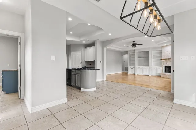 a view of a kitchen with kitchen island granite countertop a refrigerator and a sink