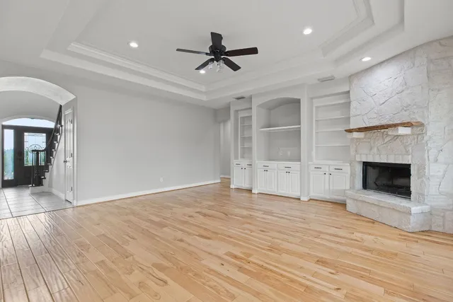a view of an empty room with a fireplace and a window