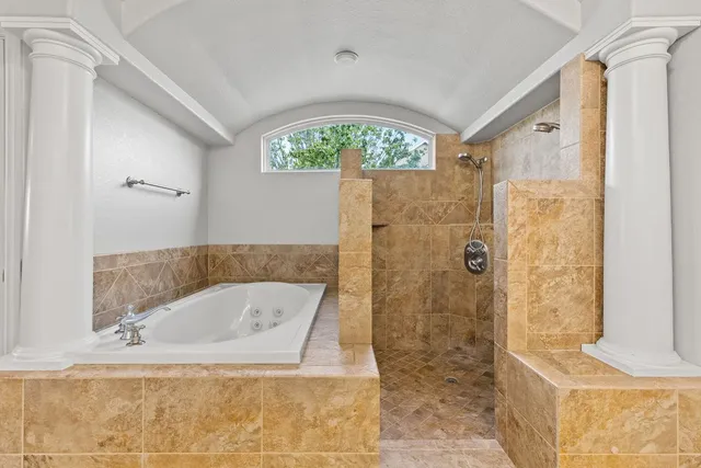 a bathroom with a tub shower and sink