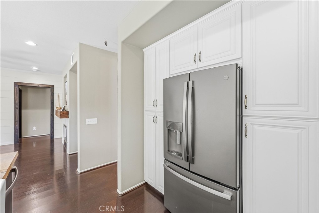 8402 Lindenhurst Street Riverside, CA 92508 - Photo 20 of 60 a view of a kitchen with refrigerator and wooden floor