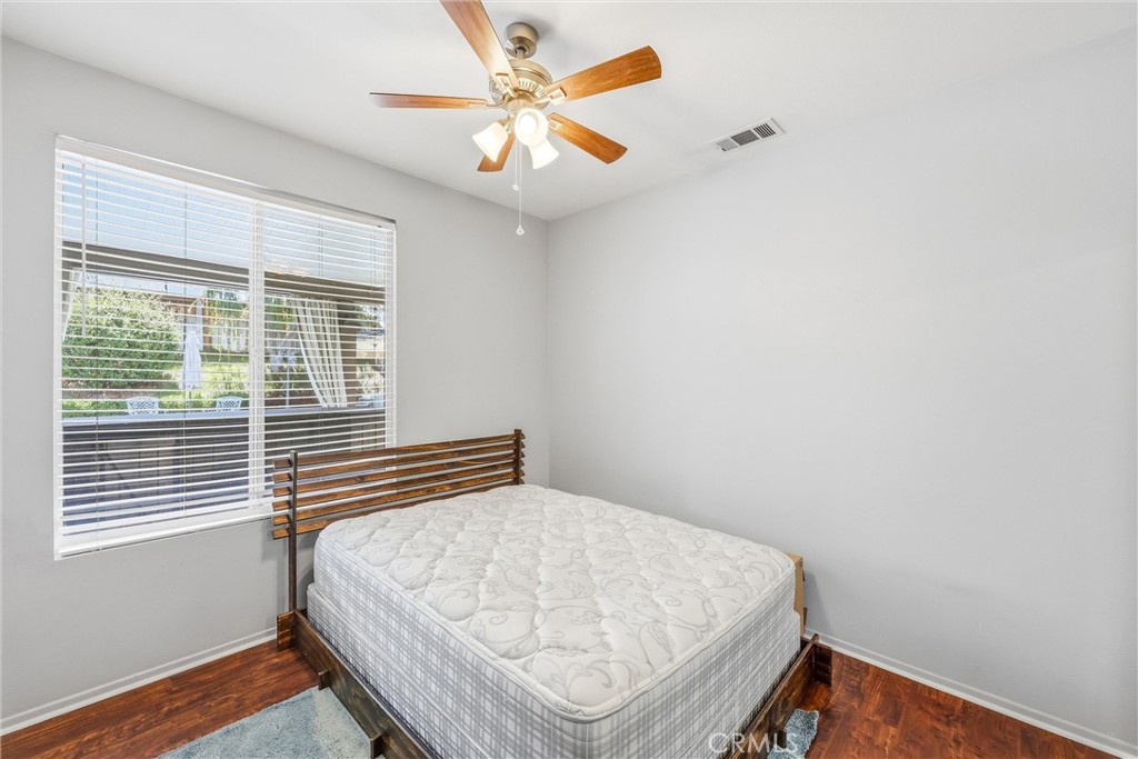 8402 Lindenhurst Street Riverside, CA 92508 - Photo 21 of 60 a bedroom with a bed and a window