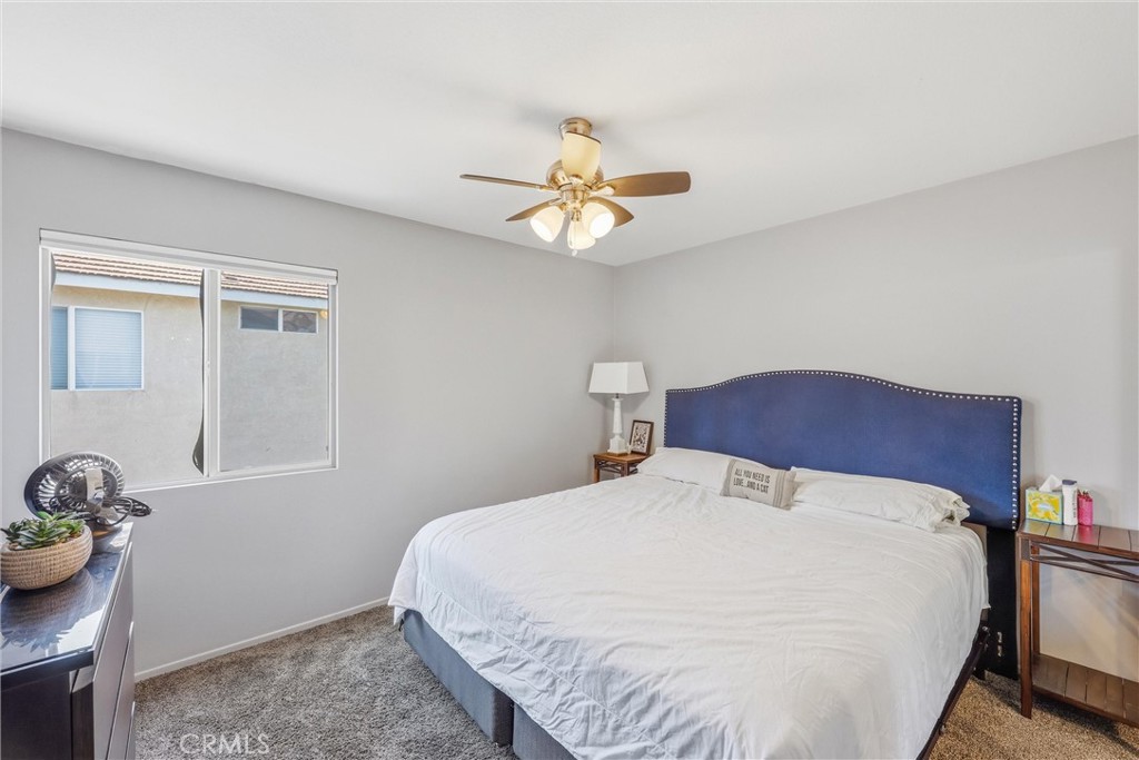 8402 Lindenhurst Street Riverside, CA 92508 - Photo 28 of 60 a bedroom with a bed and a chandelier