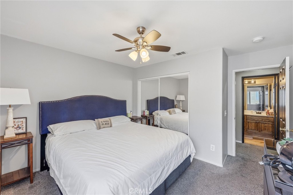 8402 Lindenhurst Street Riverside, CA 92508 - Photo 29 of 60 a bedroom with a bed and a chandelier