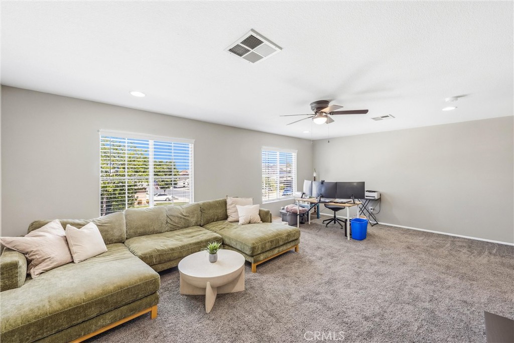 8402 Lindenhurst Street Riverside, CA 92508 - Photo 32 of 60 a living room with furniture and a large window