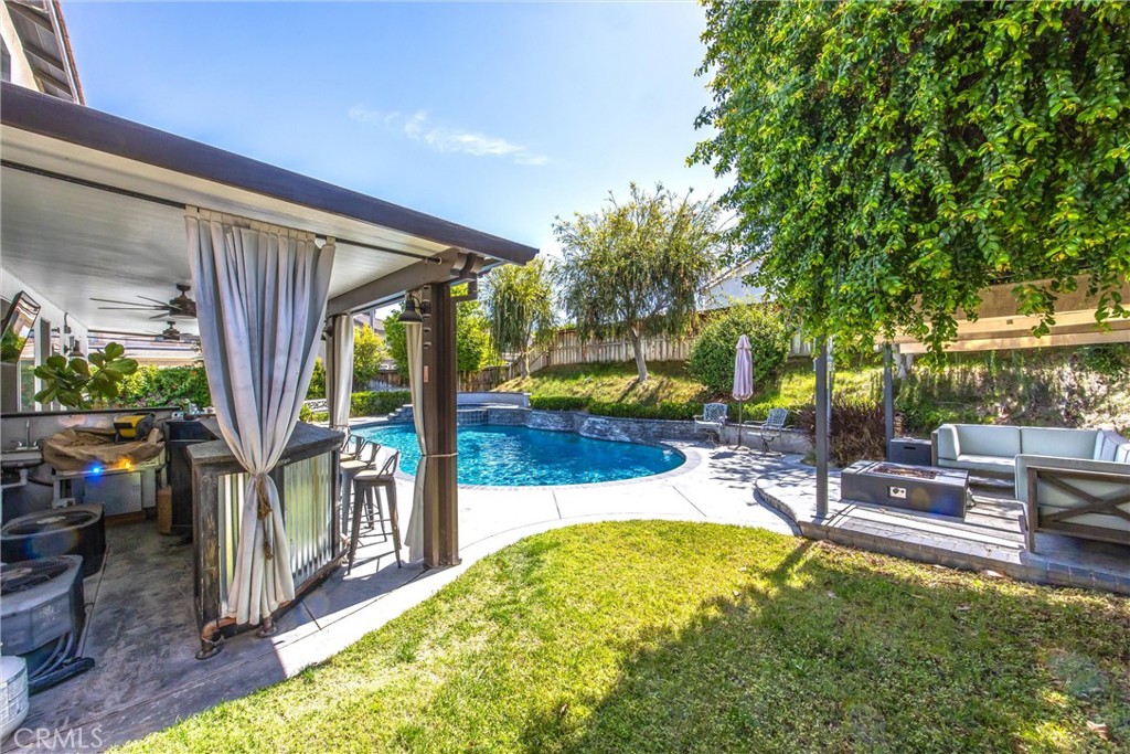8402 Lindenhurst Street Riverside, CA 92508 - Photo 33 of 60 a view of a swimming pool with a patio