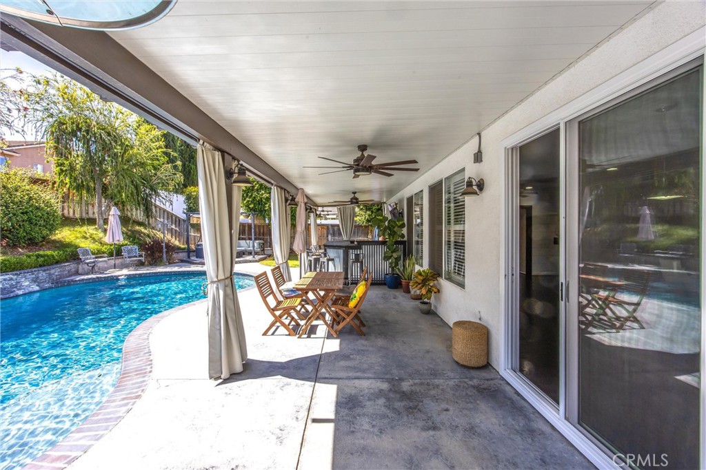 8402 Lindenhurst Street Riverside, CA 92508 - Photo 38 of 60 a view of a porch with chairs and backyard