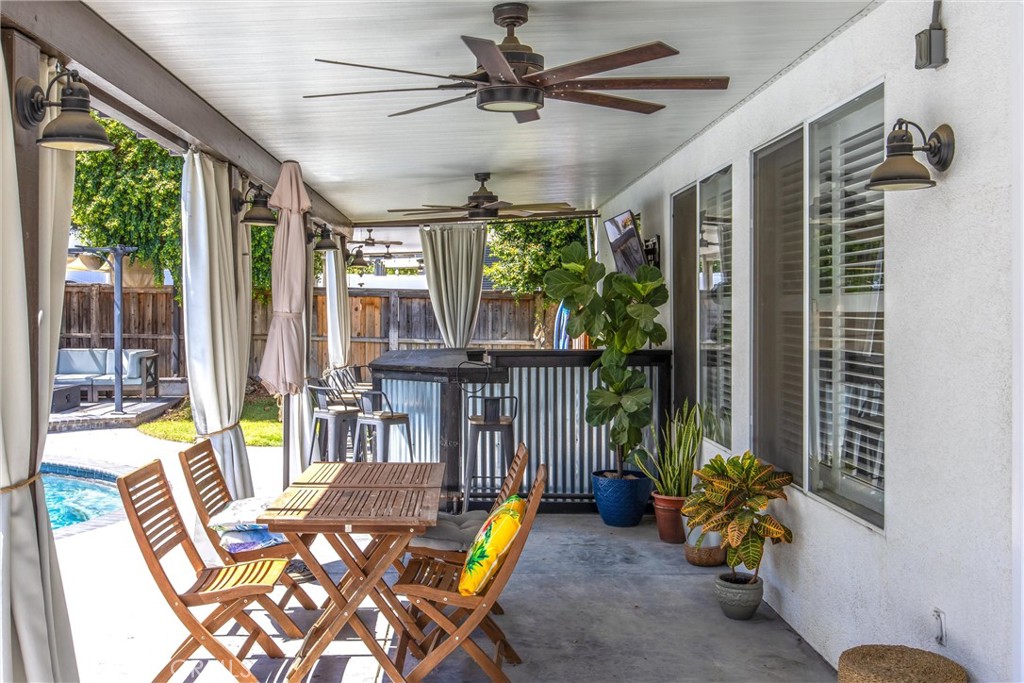 8402 Lindenhurst Street Riverside, CA 92508 - Photo 39 of 60 a view of a porch with chairs and a potted plant