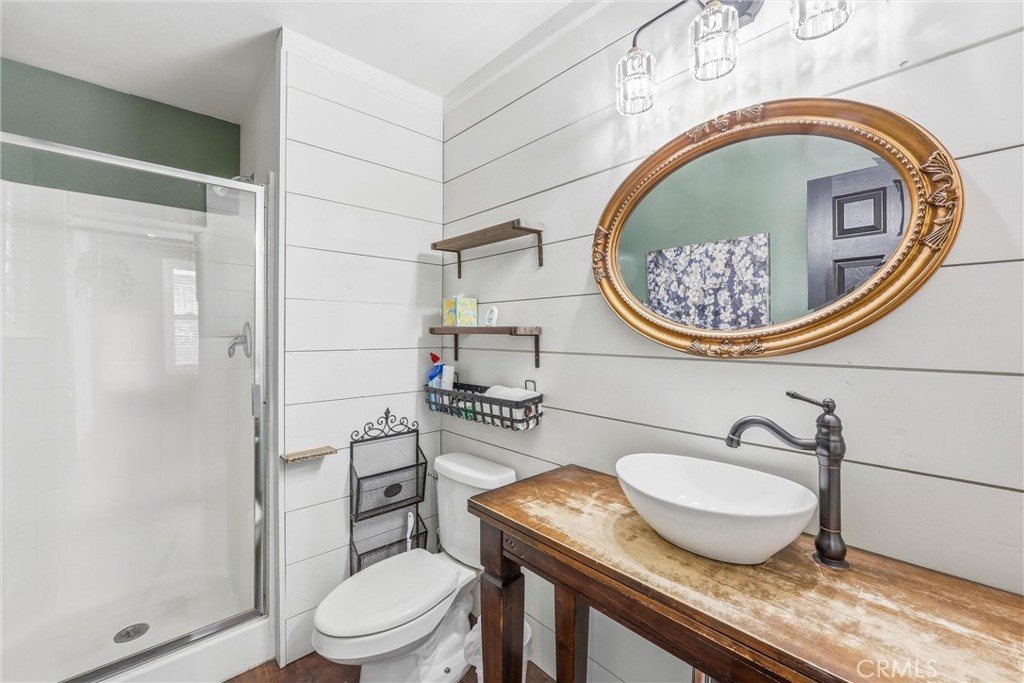 8402 Lindenhurst Street Riverside, CA 92508 - Photo 4 of 60 a bathroom with a granite countertop toilet sink and mirror