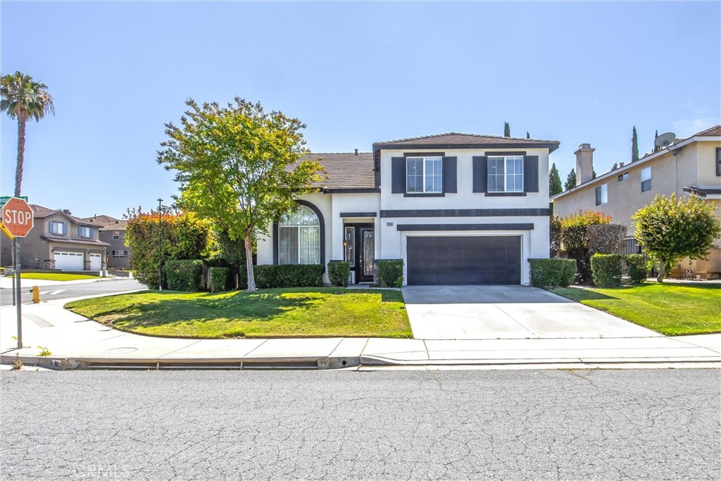 8402 Lindenhurst Street Riverside, CA 92508 - Photo 45 of 60 a front view of a house with a yard and garage