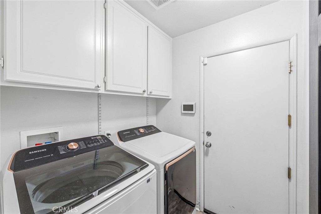 8402 Lindenhurst Street Riverside, CA 92508 - Photo 10 of 60 a utility room with dryer and washer